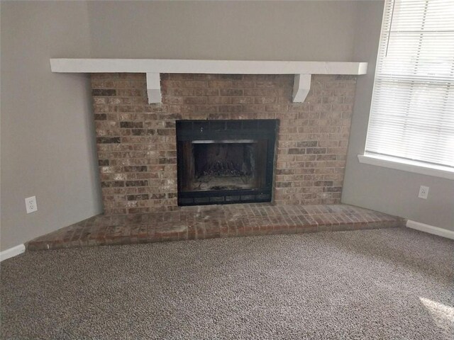 interior details with baseboards, carpet floors, and a fireplace