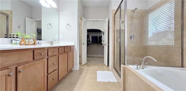 bathroom with shower with separate bathtub, tile patterned floors, and vanity