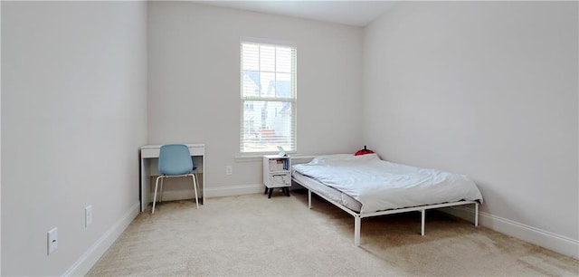 bedroom with light carpet and multiple windows