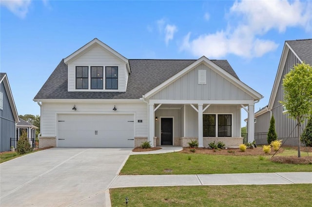 view of front of house featuring roof with shingles, driveway, a front lawn, brick siding, and a garage