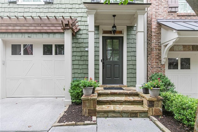 doorway to property featuring a garage and driveway