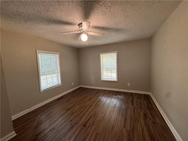 unfurnished room featuring ceiling fan, a textured ceiling, and dark hardwood / wood-style flooring