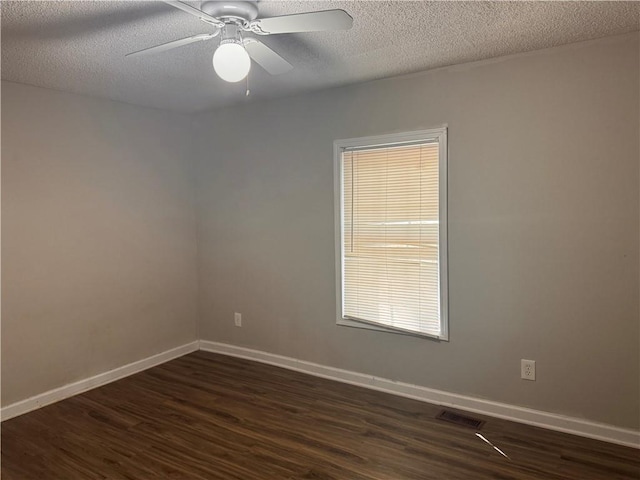 unfurnished room featuring ceiling fan, dark hardwood / wood-style floors, and a textured ceiling