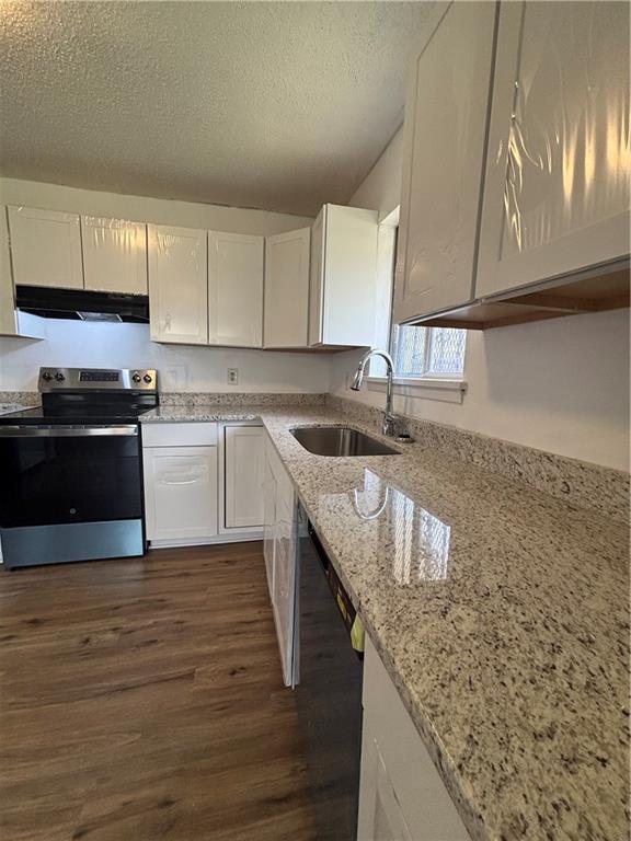 2830 Norgate Ln, Decatur, GA 30034 - kitchen featuring white cabinetry, dark wood finished floors, a sink, stainless steel range with electric cooktop, and extractor fan