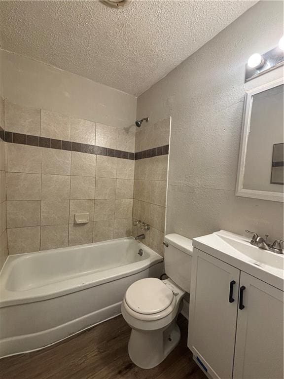 2830 Norgate Ln, Decatur, GA 30034 - bathroom with bathtub / shower combination, toilet, wood finished floors, a textured ceiling, and a textured wall