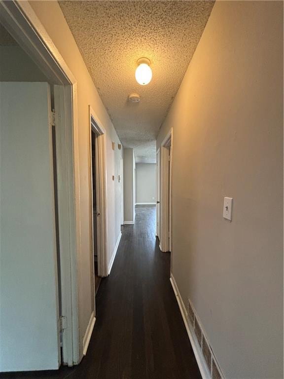 2830 Norgate Ln, Decatur, GA 30034 - corridor with baseboards, visible vents, dark wood-type flooring, and a textured ceiling