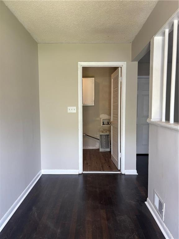 2830 Norgate Ln, Decatur, GA 30034 - spare room featuring baseboards, a textured ceiling, visible vents, and wood finished floors