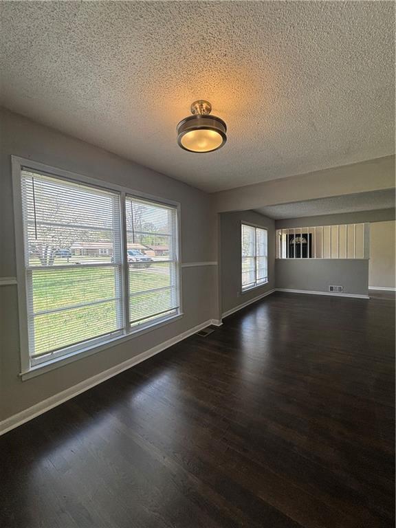 2830 Norgate Ln, Decatur, GA 30034 - spare room with dark wood-style floors, visible vents, baseboards, and a textured ceiling