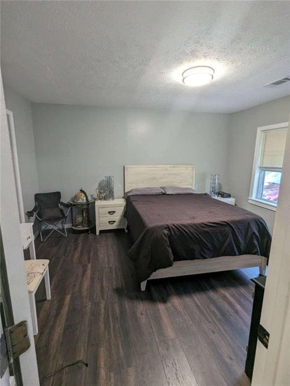 6977 Eunice Dr, Riverdale, GA 30274 - bedroom with dark hardwood / wood-style floors and a textured ceiling