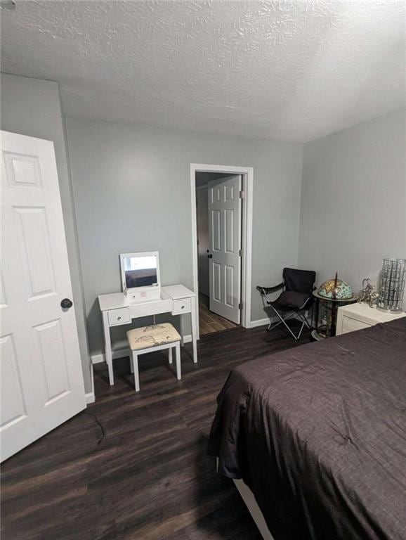 6977 Eunice Dr, Riverdale, GA 30274 - bedroom with dark hardwood / wood-style flooring and a textured ceiling