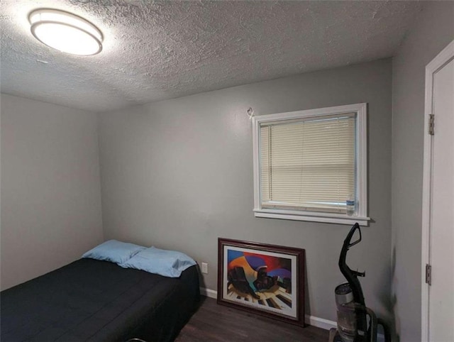6977 Eunice Dr, Riverdale, GA 30274 - bedroom with dark hardwood / wood-style floors and a textured ceiling