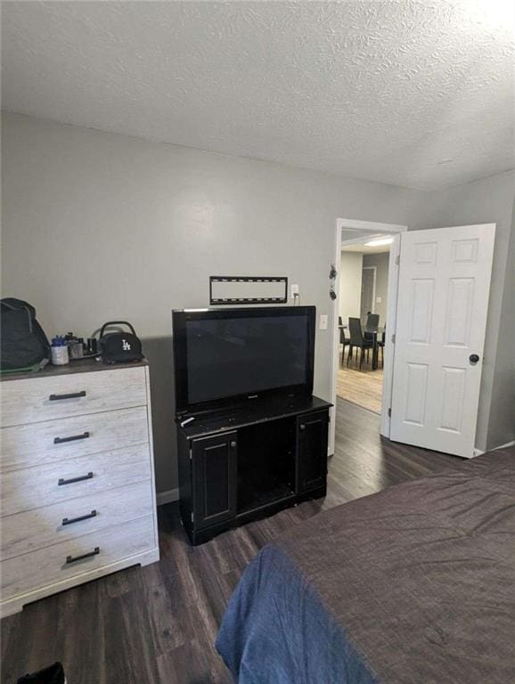 6977 Eunice Dr, Riverdale, GA 30274 - bedroom with dark wood-type flooring and a textured ceiling