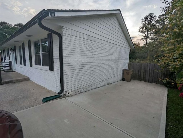 6977 Eunice Dr, Riverdale, GA 30274 - property exterior at dusk with a patio