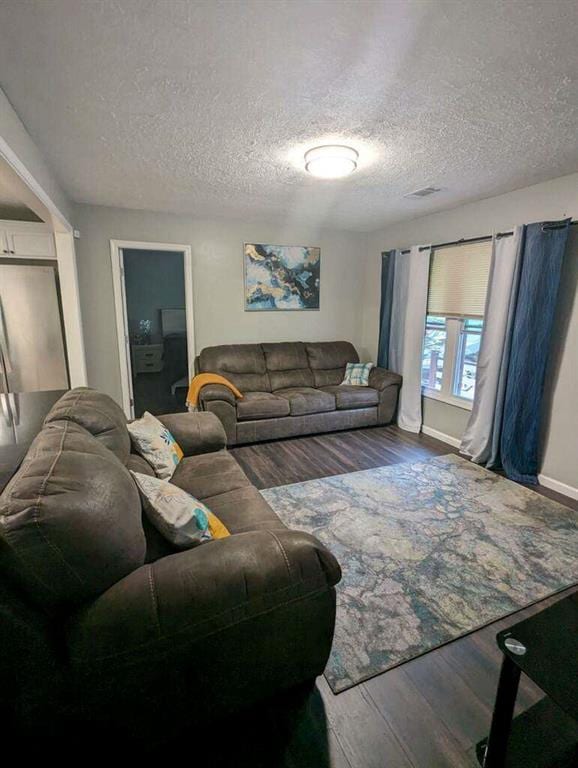 6977 Eunice Dr, Riverdale, GA 30274 - living room featuring wood-type flooring and a textured ceiling