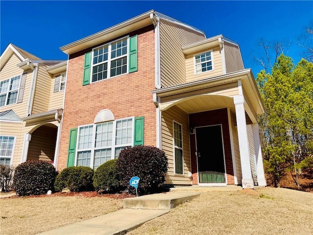 view of front of home featuring brick siding