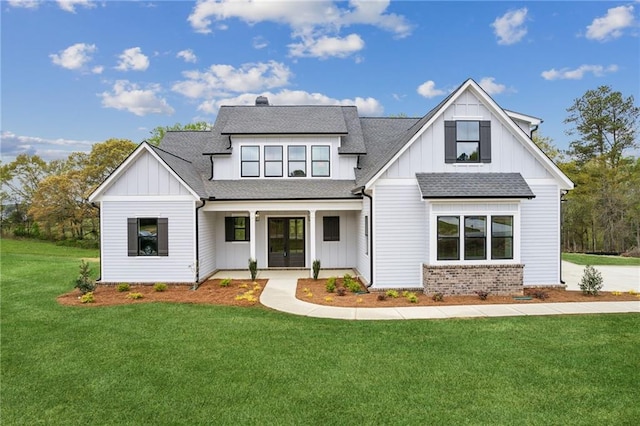 modern farmhouse style home featuring a front yard and french doors