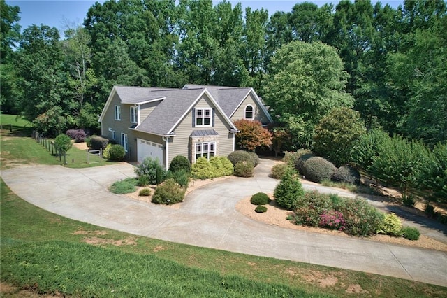 front facade with a garage and a front lawn