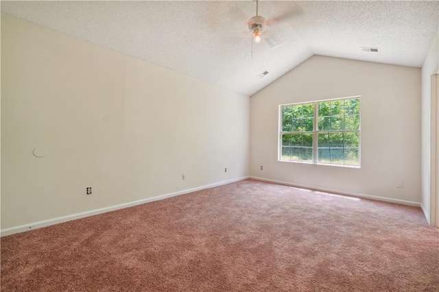 carpeted spare room with vaulted ceiling, ceiling fan, and a textured ceiling