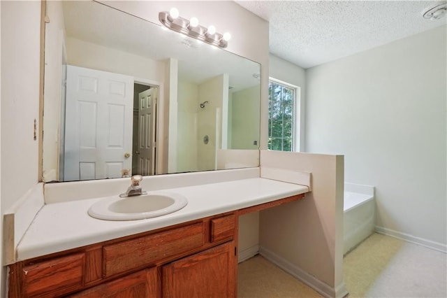 bathroom featuring vanity, separate shower and tub, and a textured ceiling