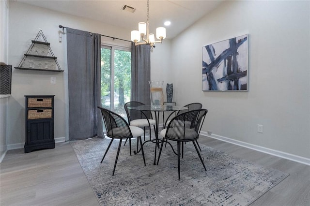 dining room featuring a chandelier and hardwood / wood-style flooring