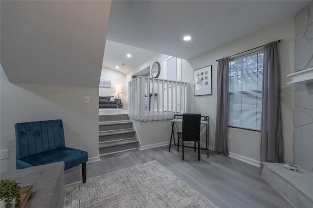 living area featuring hardwood / wood-style floors and vaulted ceiling