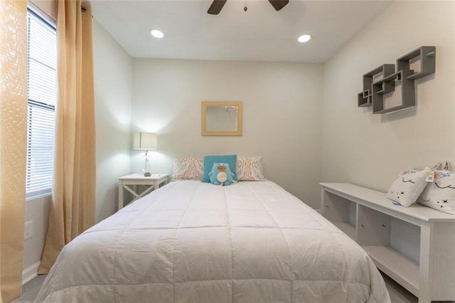 bedroom with multiple windows and ceiling fan