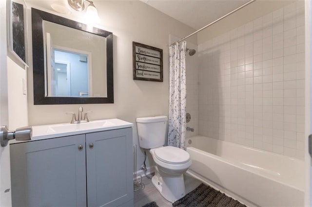 full bathroom with shower / tub combo with curtain, vanity, and toilet