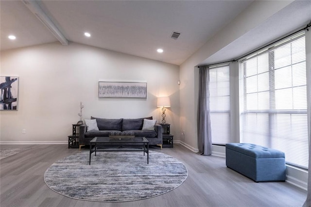 living room with vaulted ceiling with beams and hardwood / wood-style flooring