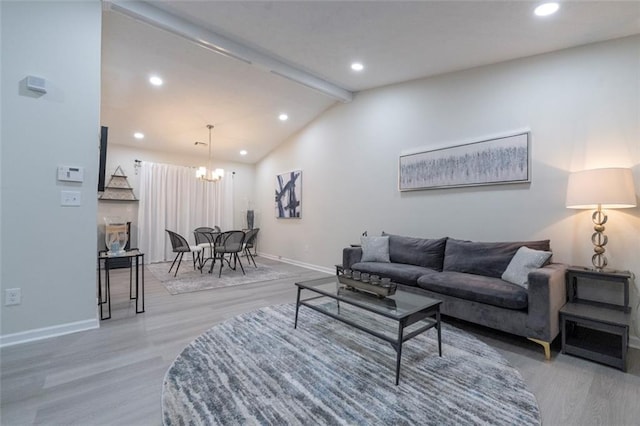 living room featuring hardwood / wood-style flooring, a notable chandelier, and vaulted ceiling with beams