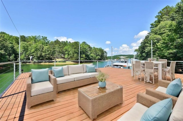 deck with an outdoor hangout area and a water view