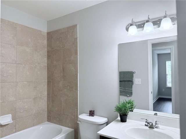 bathroom with toilet, vanity, and shower / tub combination