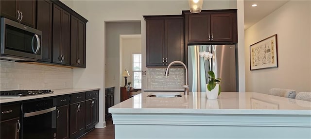 2962 Girard Ln, Duluth, GA 30097 - kitchen featuring stainless steel appliances, a sink, backsplash, recessed lighting, and dark brown cabinets