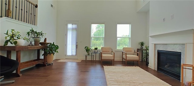 2962 Girard Ln, Duluth, GA 30097 - foyer featuring a fireplace, wood finished floors, a towering ceiling, and baseboards