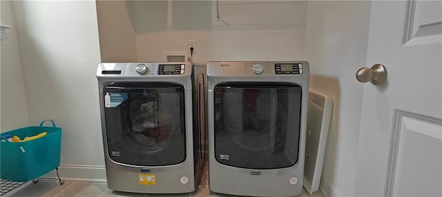 2962 Girard Ln, Duluth, GA 30097 - laundry area featuring separate washer and dryer, baseboards, and tile patterned floors