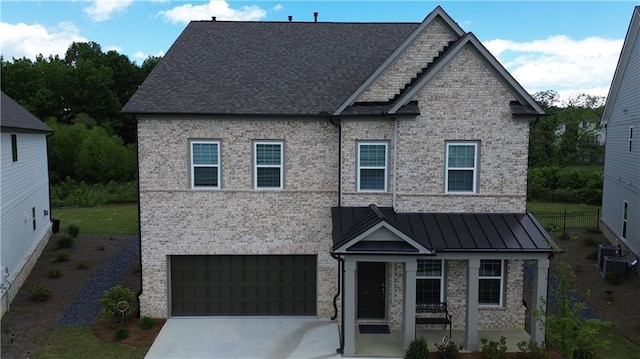 2962 Girard Ln, Duluth, GA 30097 - view of front of house featuring an attached garage, driveway, a standing seam roof, and brick siding