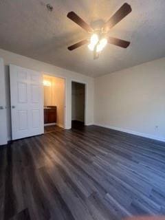 unfurnished bedroom with baseboards, a ceiling fan, wood finished floors, and a closet