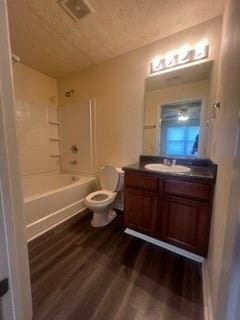 bathroom featuring toilet, washtub / shower combination, wood finished floors, and vanity