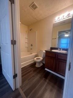 full bath featuring bathtub / shower combination, vanity, toilet, wood finished floors, and visible vents
