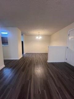 spare room with baseboards and wood finished floors