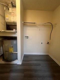 laundry room with baseboards, laundry area, and wood finished floors