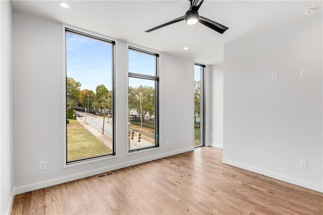 spare room with ceiling fan and light hardwood / wood-style flooring