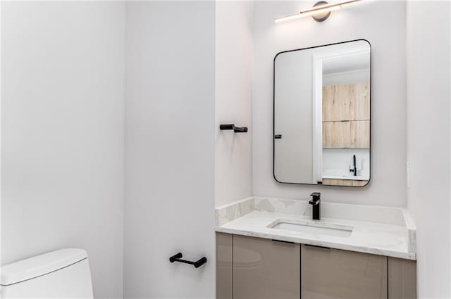 bathroom with toilet and vanity