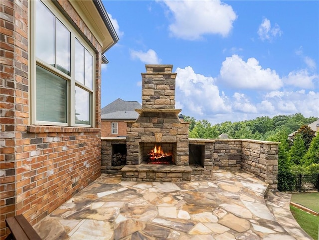 view of patio / terrace featuring an outdoor stone fireplace