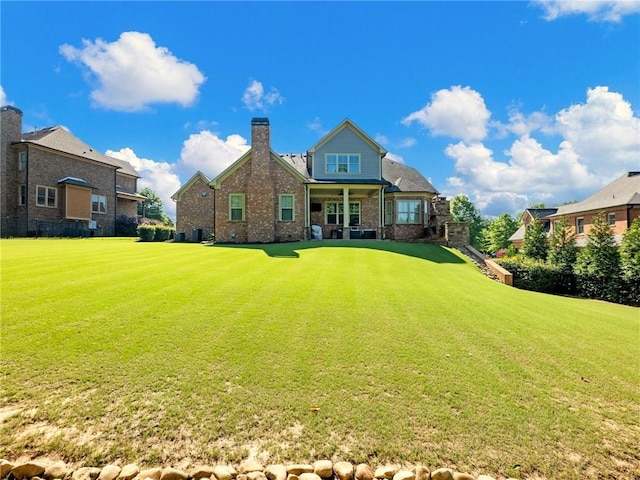 rear view of house with a yard