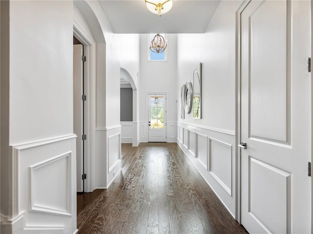 interior space featuring a chandelier and dark hardwood / wood-style floors