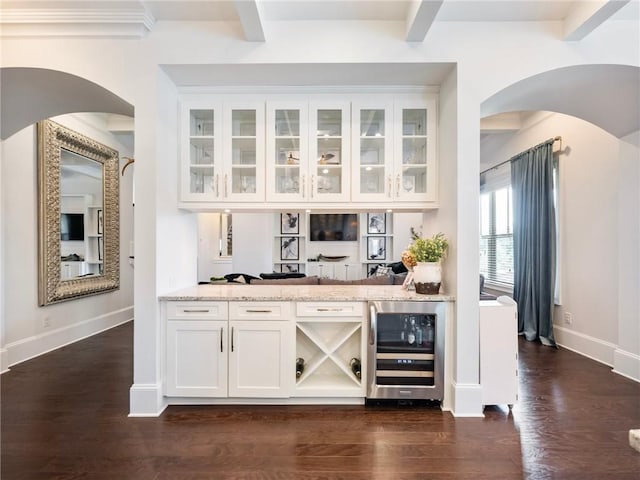 bar featuring white cabinets, light stone countertops, beverage cooler, dark hardwood / wood-style floors, and beam ceiling