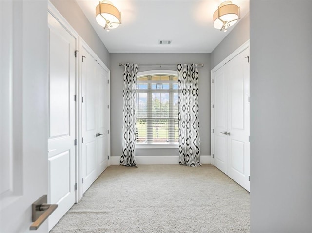 interior space featuring light colored carpet