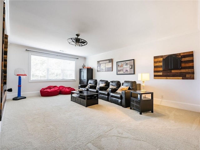 carpeted living room featuring ceiling fan