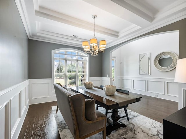 dining room with a notable chandelier, crown molding, and dark hardwood / wood-style flooring