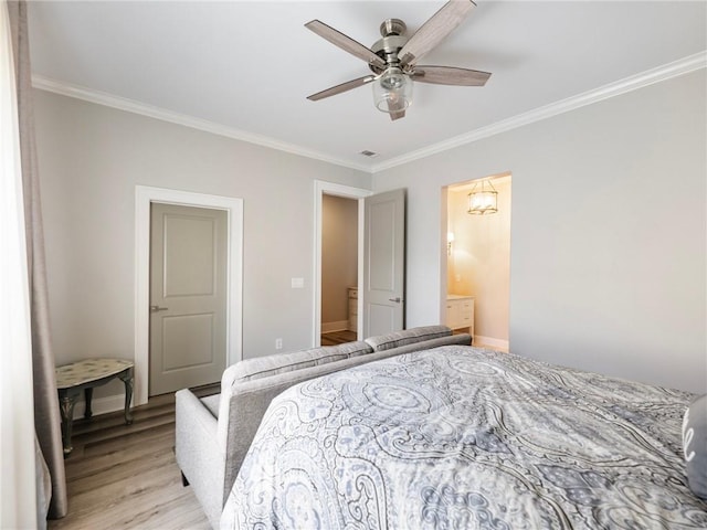 bedroom featuring ceiling fan, crown molding, light hardwood / wood-style floors, and connected bathroom